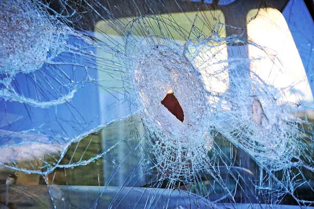 Broken truck windshield after car accident on road